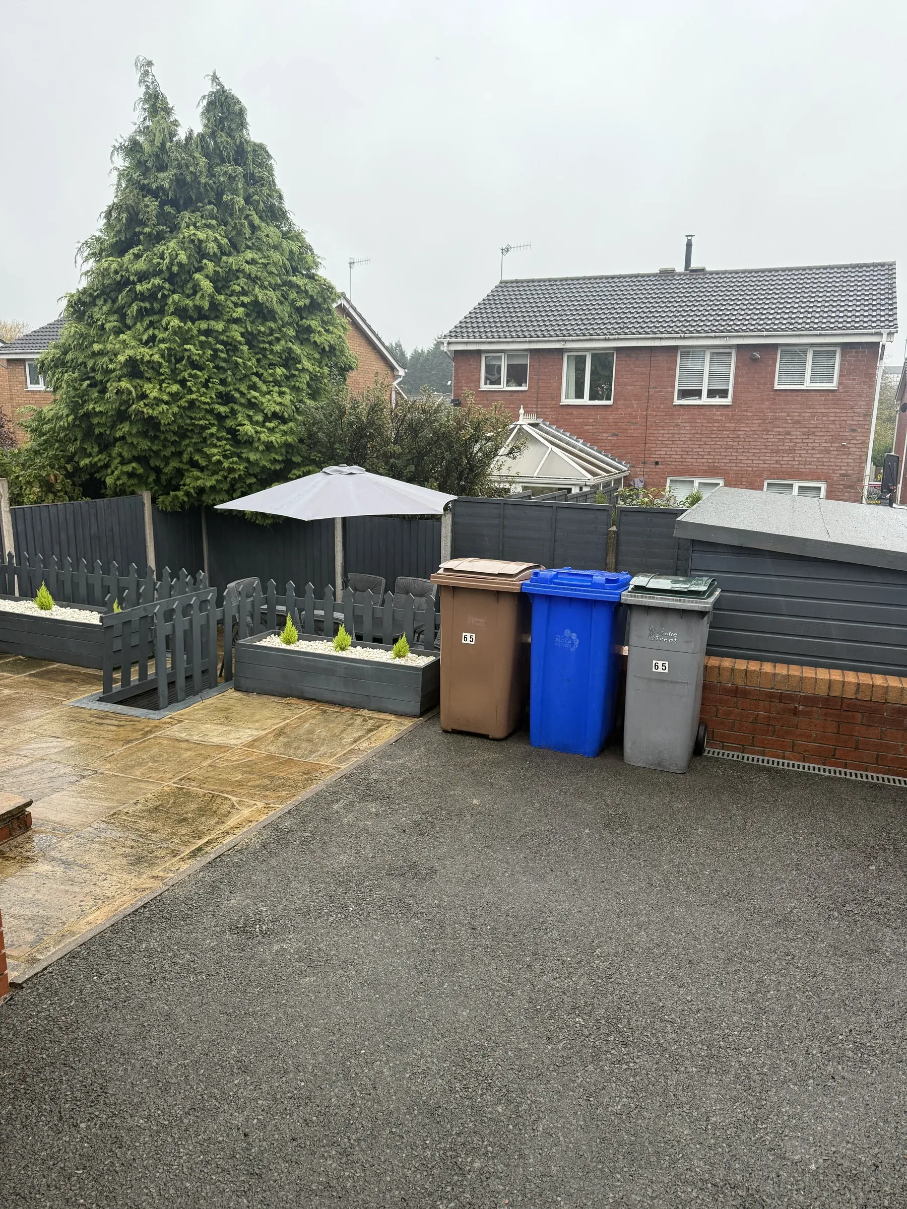 The rear garden with new fencing, gravel and bin storage
