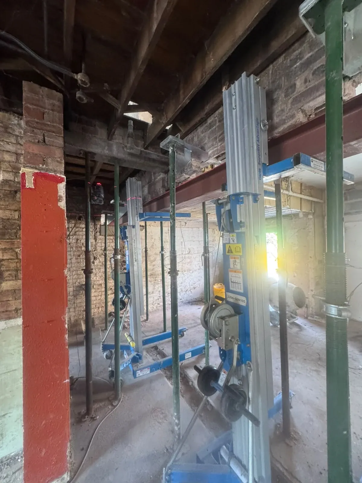 A wide view of the ground floor with rows of adjustable props and new steelwork