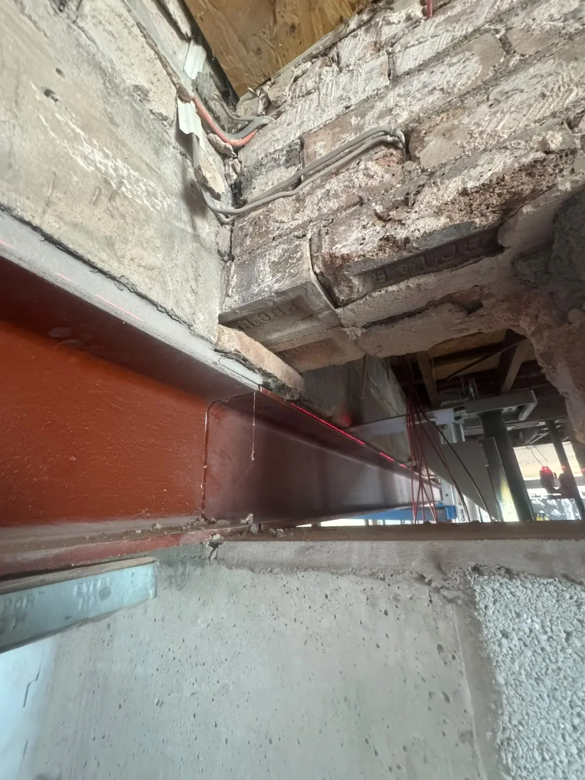 A steel beam bearing onto a masonry pier, with the surrounding brickwork exposed