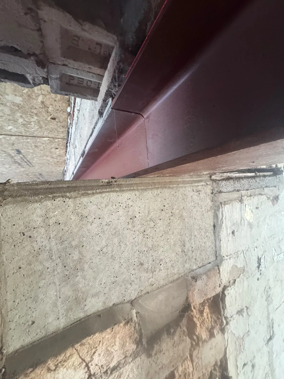 Close detail of a steel beam meeting the original masonry