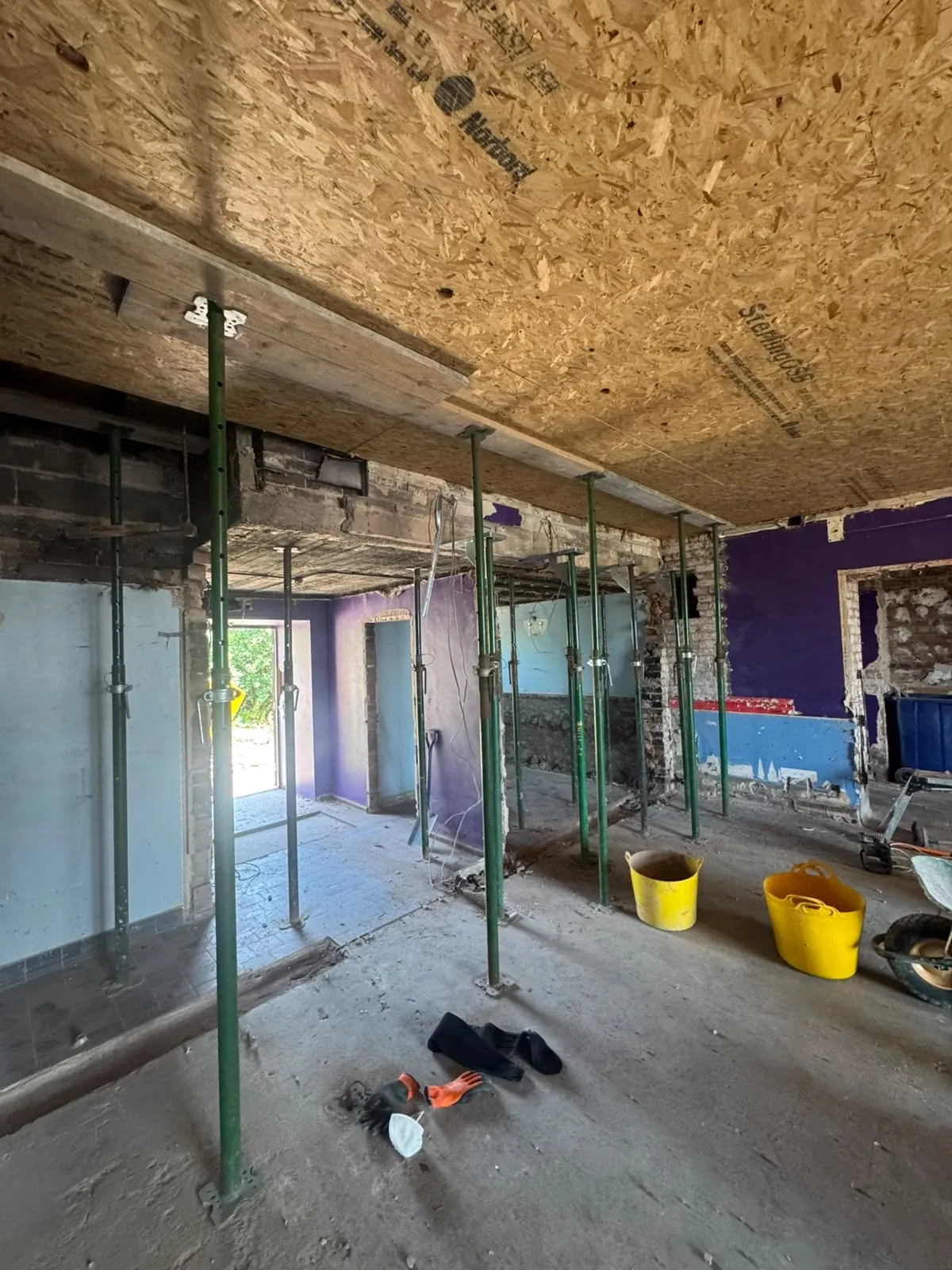 The interior stripped back to brick and joists, with temporary propping in place