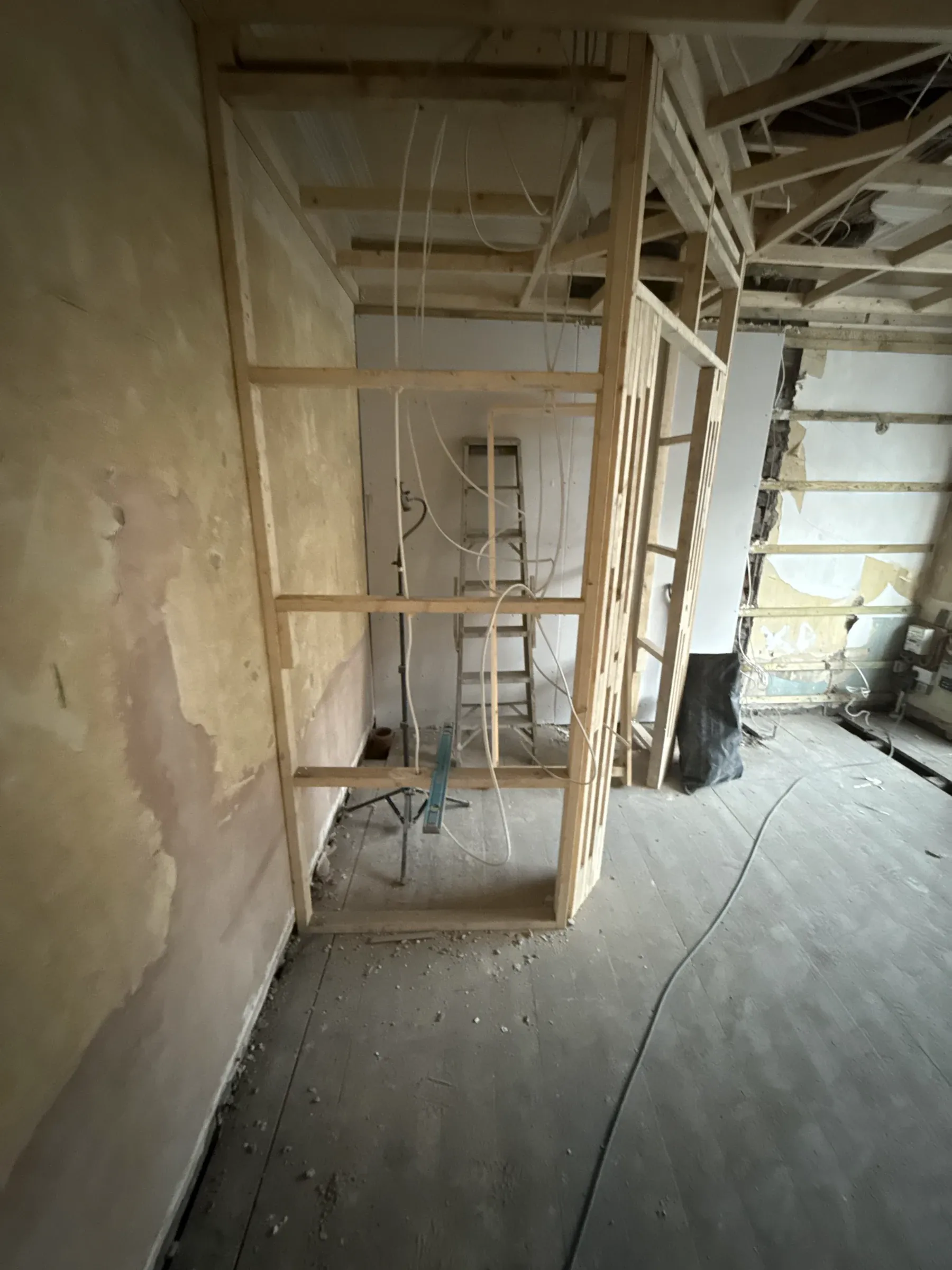 The property at strip-out, with new stud framing in and the ceiling opened up